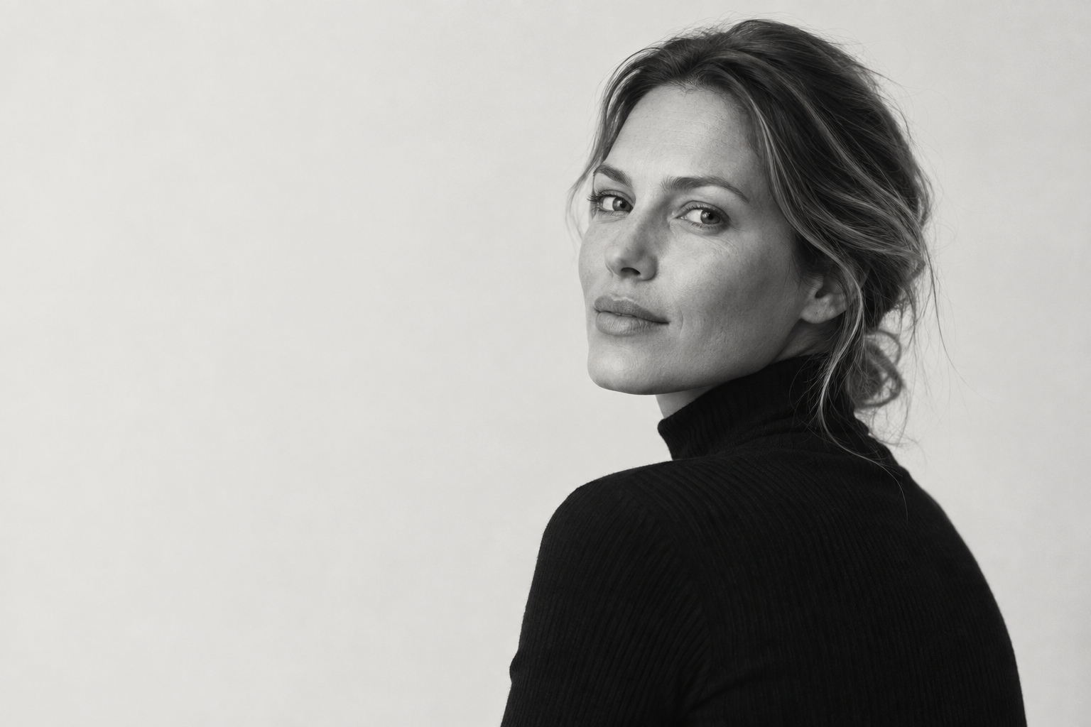 Editorial portrait of a woman in a black turtleneck